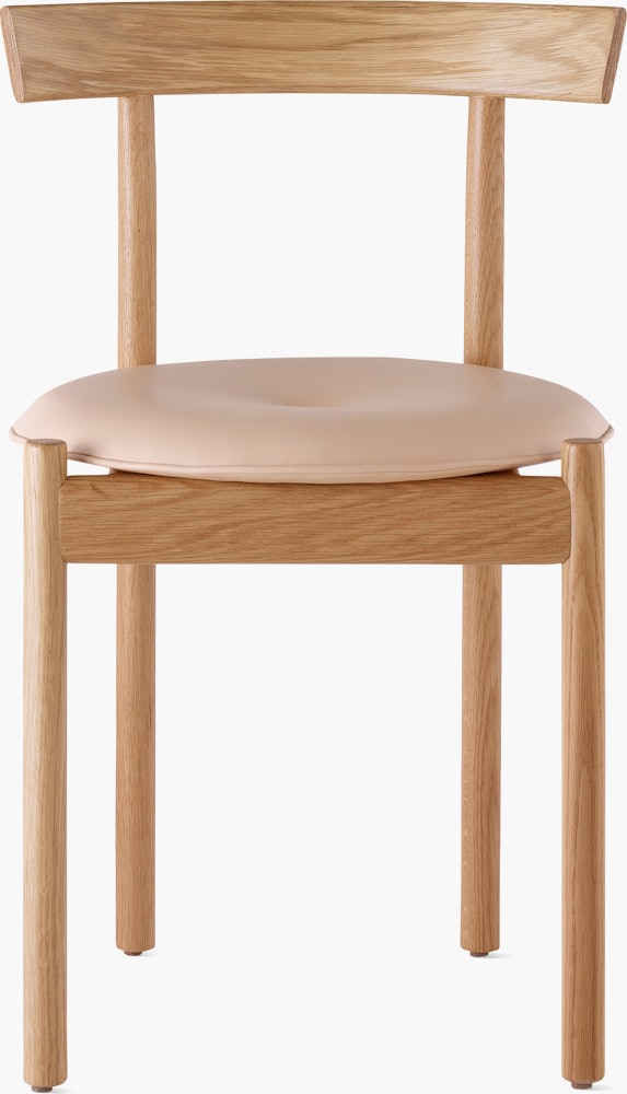 An oak Comma Chair with a seat pad, viewed from the front.