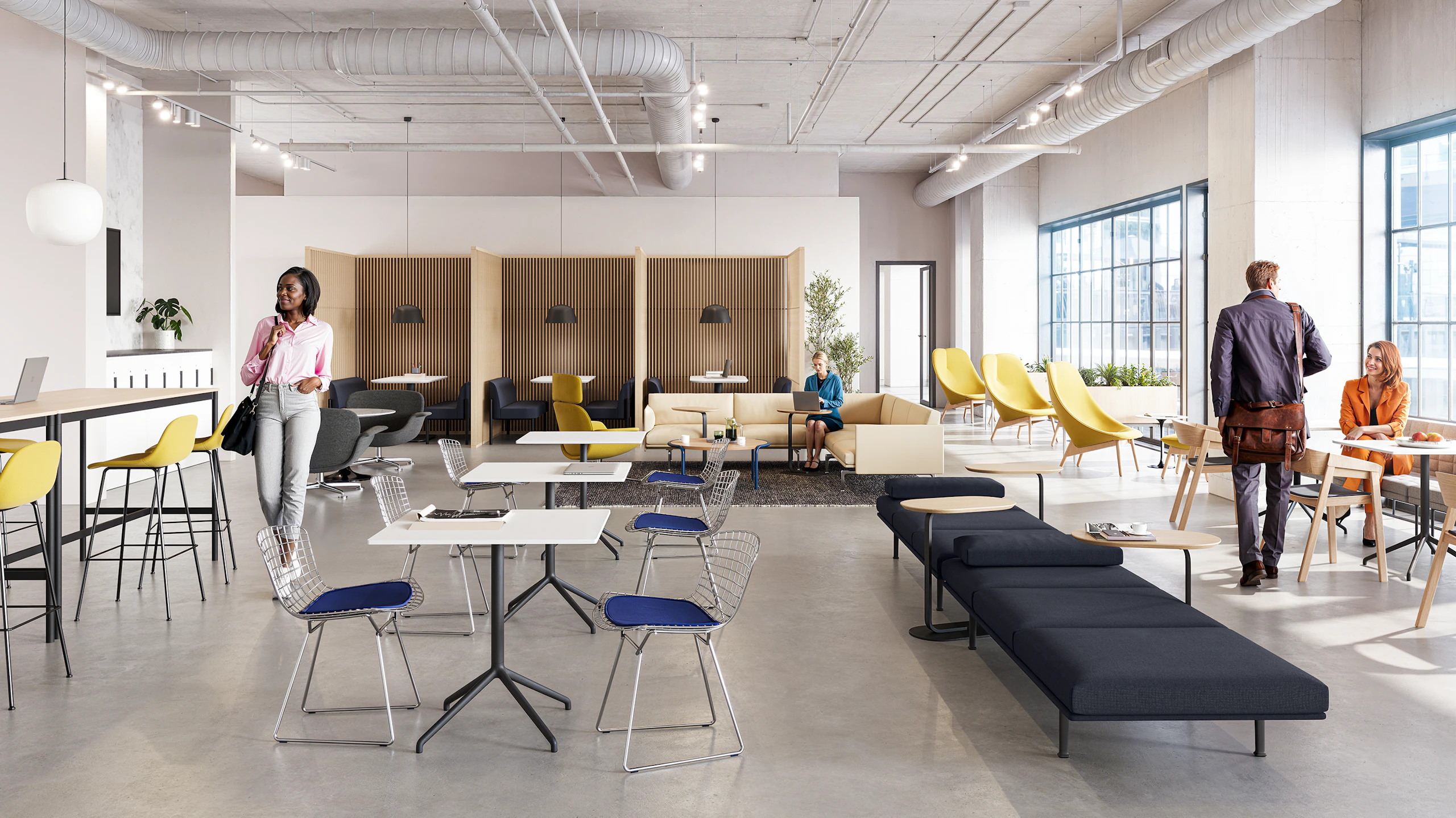 Several people utilizing a café community setting furnished with Herman Miller Overlays, Headway Tables, and Muuto Still Cafe Tables