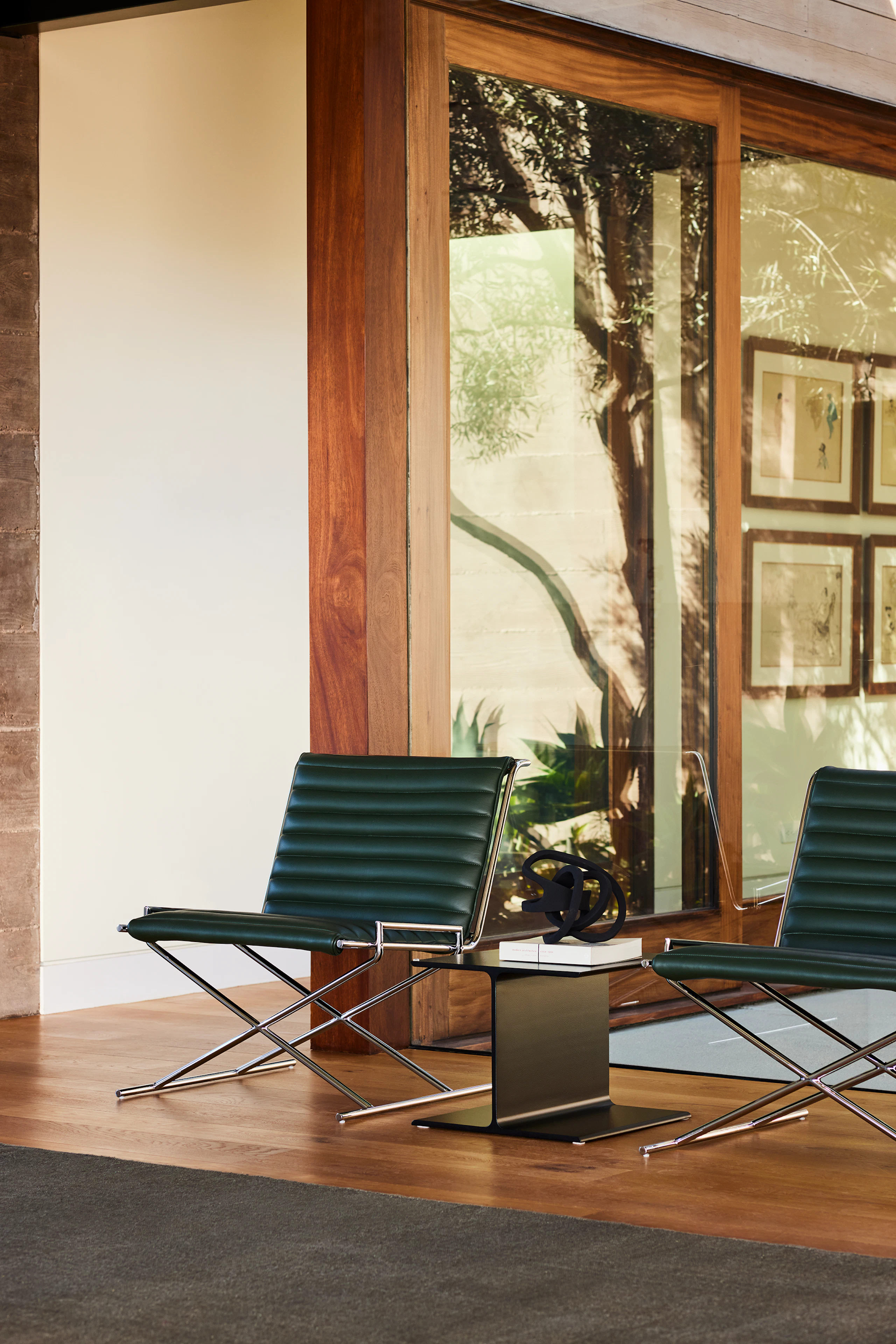 Two Sled Chairs with an I-Beam Side Table in an environmental setting.
