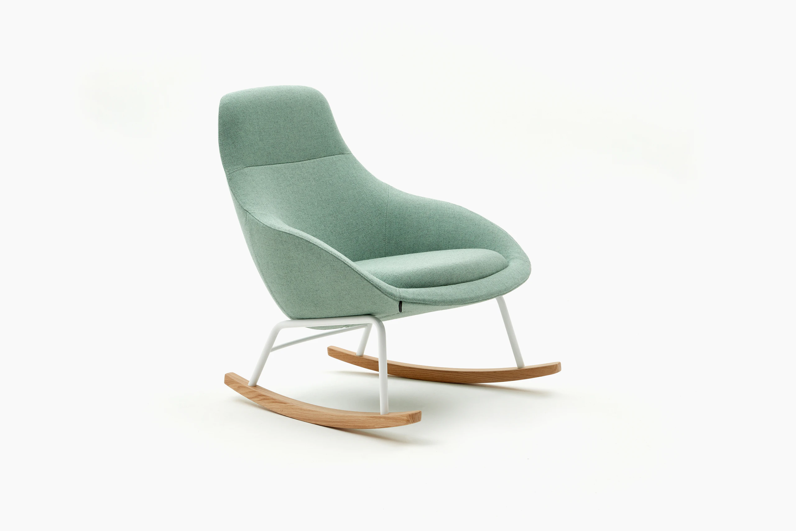 An angled view of a naughtone Always Lounge Chair with light green upholstery, fitted with a rocking chair base in white steel and hardwood.