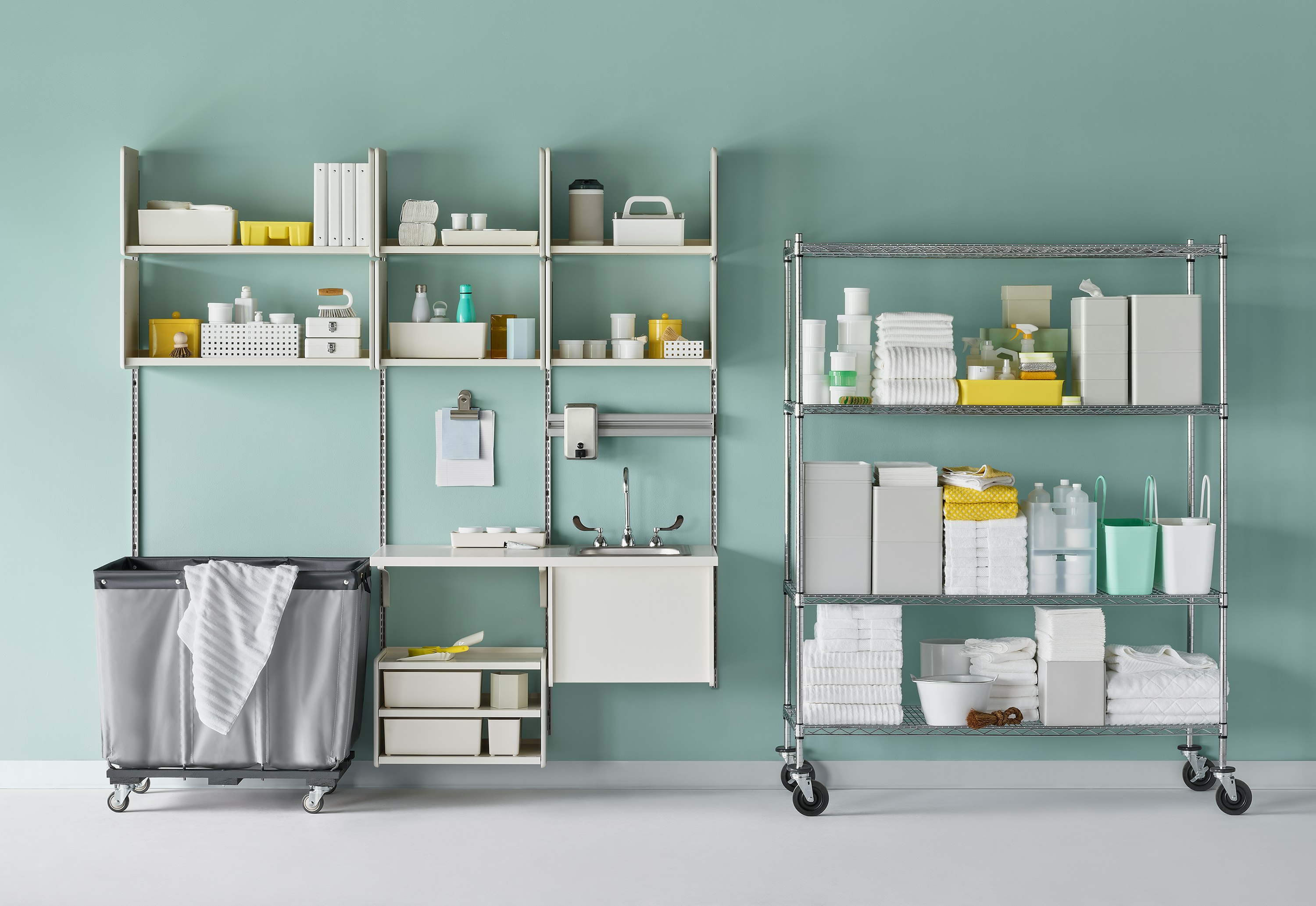 Medical soiled utility in soft white Co/Struc System including a sink and stainless steel wire shelving unit.