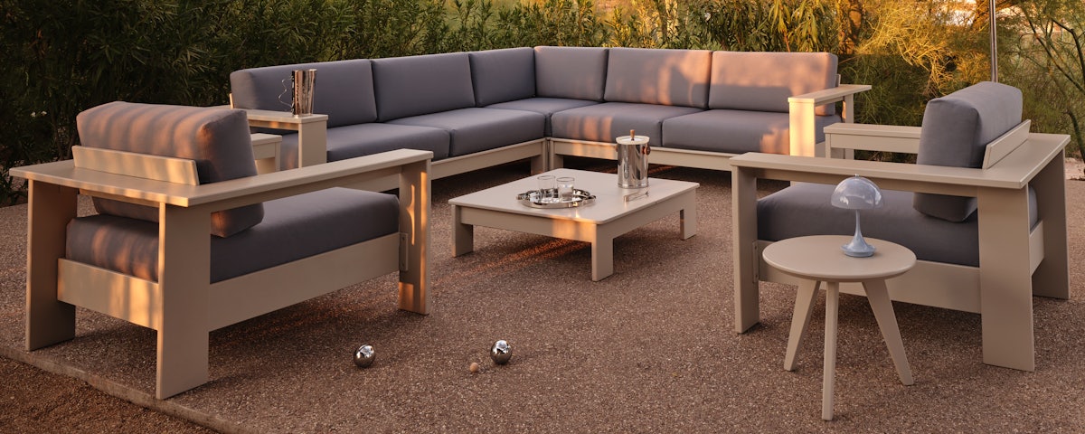 Pepin Corner Sectional and Lounge Chair in a courtyard setting
