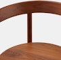 A close up detail shot of the wood seat and backrest of a Comma Chair with arms.