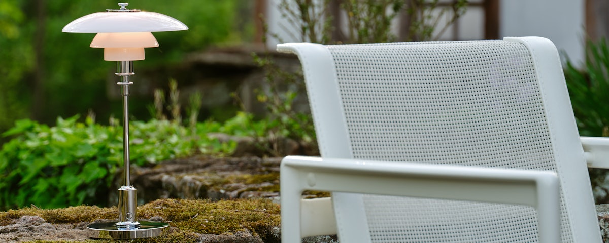 PH 2-1 Portable Light on a patio stone wall