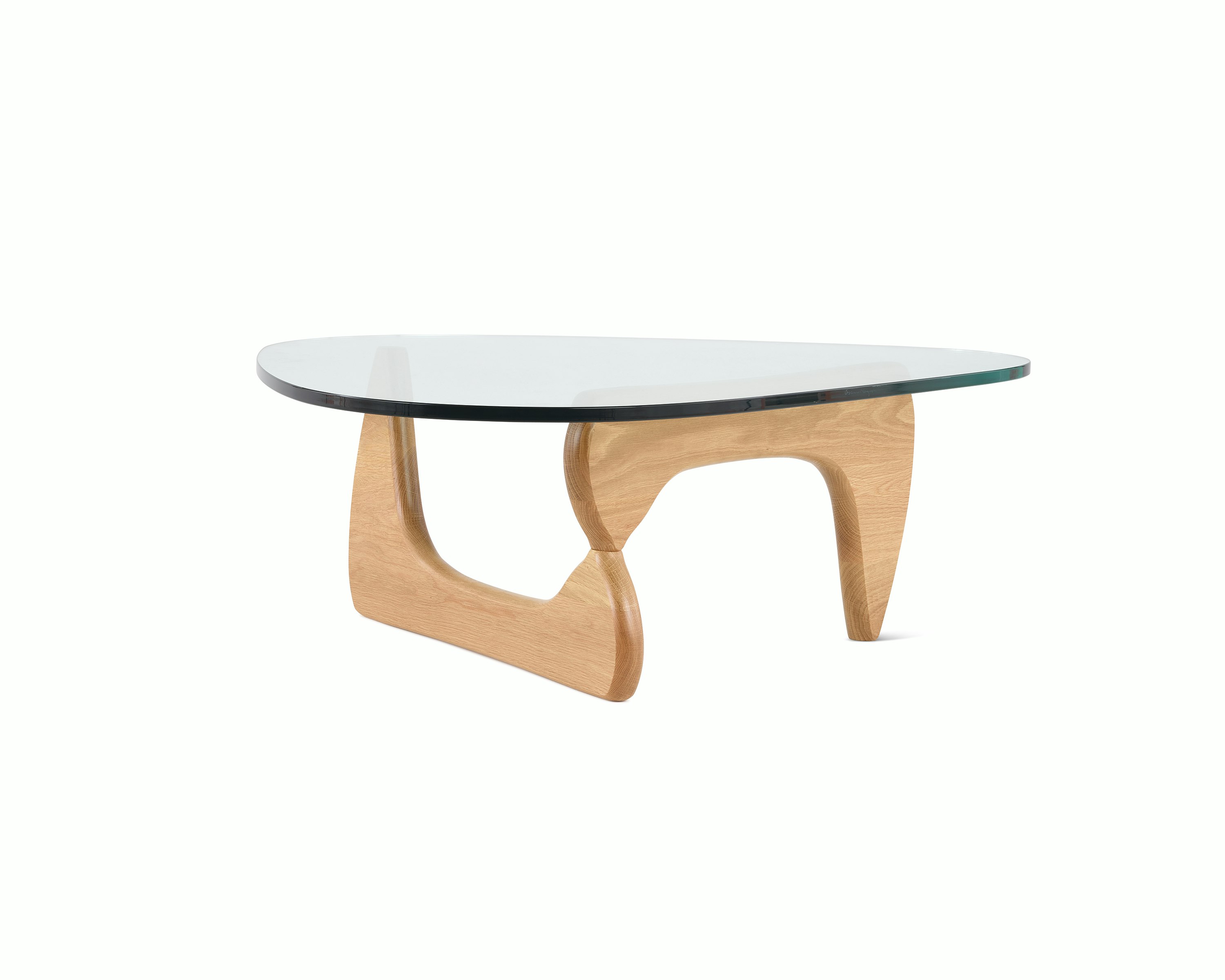 A Noguchi Table with light wood base and glass top.