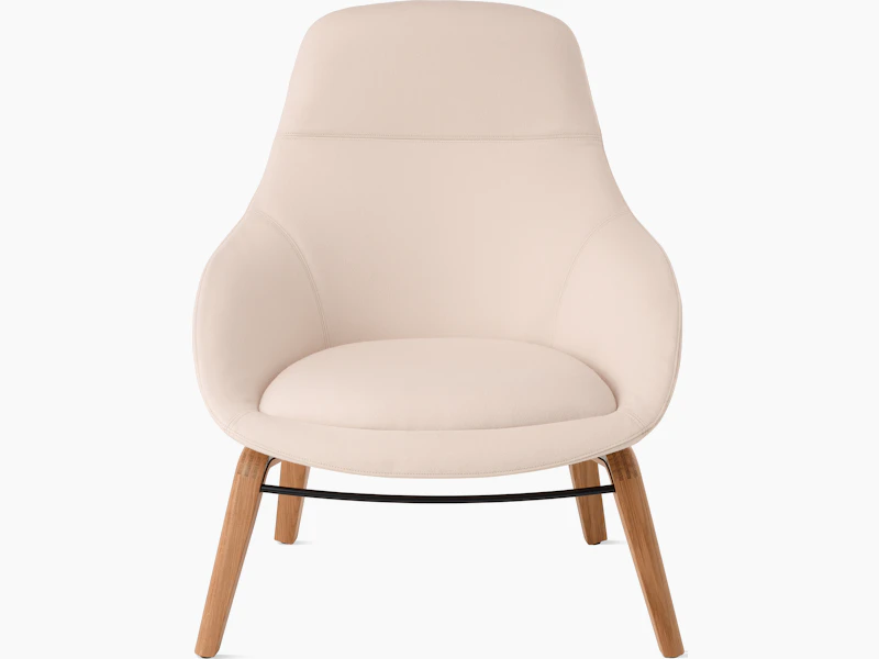 White background shot of Always Lounge Chair with cream fabric and wooden legs.