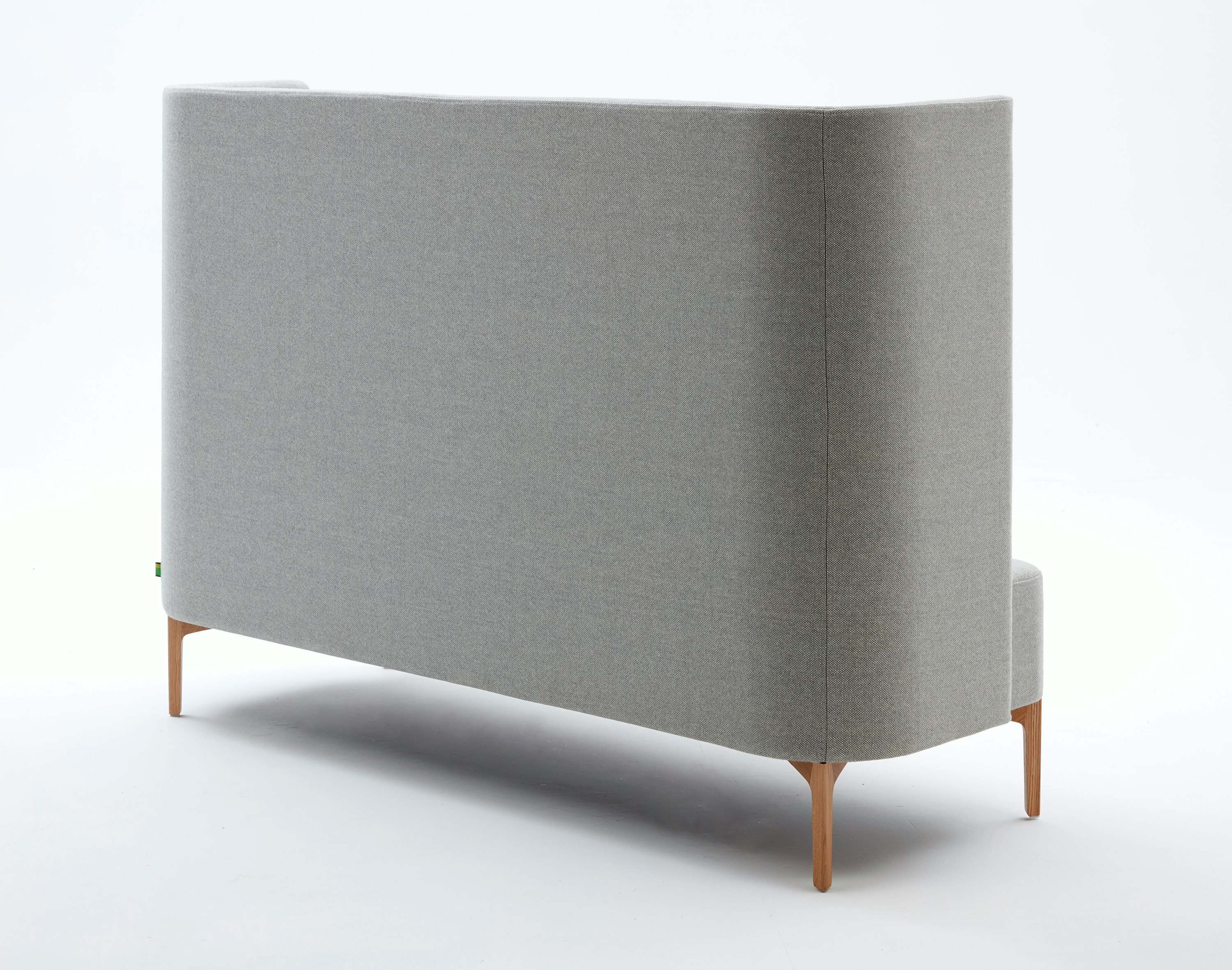 Rear view of 3 seat highback Pullman Sofa upholstered in pale grey fabric with oak legs.