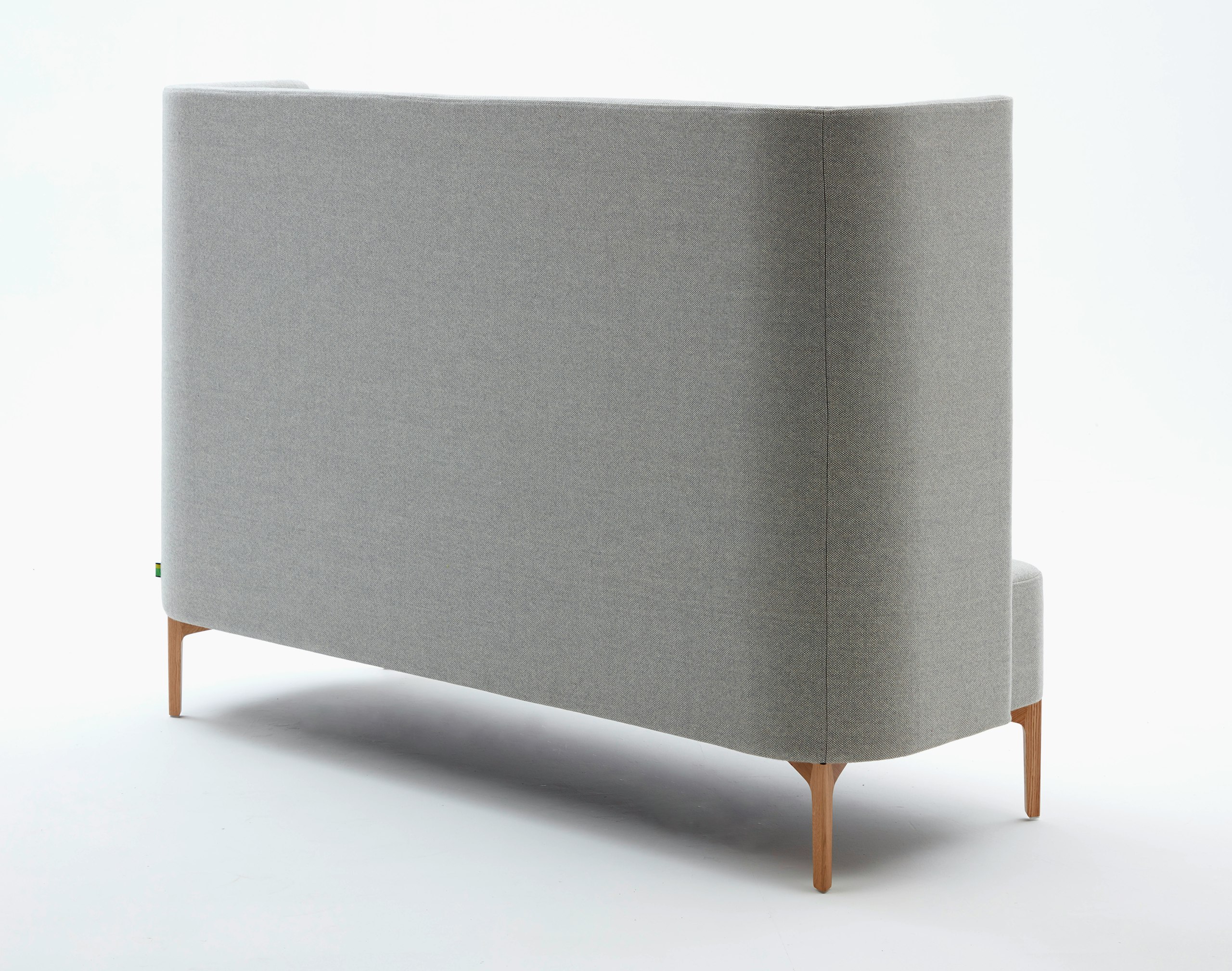 Rear view of 3 seat highback Pullman Sofa upholstered in pale grey fabric with oak legs.