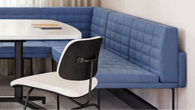 A blue Geiger Tuxedo Component Lounge, black and white Knoll Grasshopper Table, and white Knoll Bertoia chair used in a group conference room setting that considers the wellbeing of employees