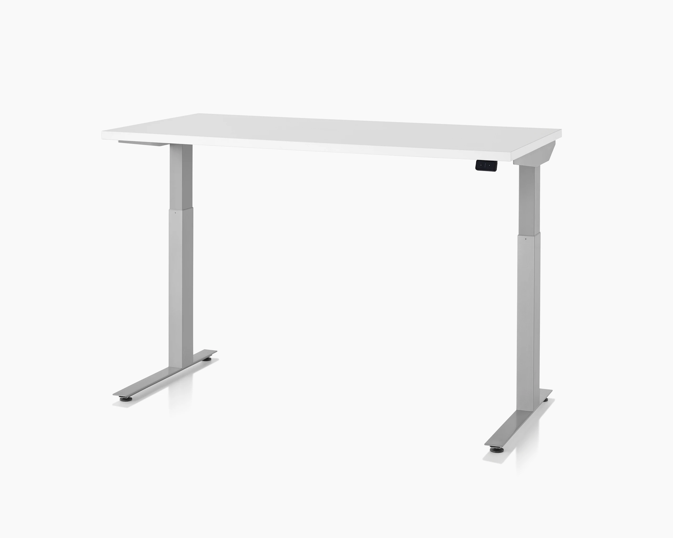 A three-quarter view of a white top, silver leg, Nevi Sit-to-Stand Table at a standing height.