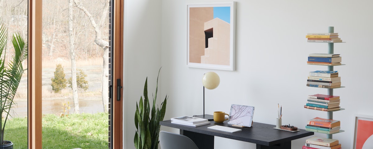 Palm Springs CA by Sinziana Velicescu over Private Desk with Saarinen Executive Plastic Chair and Story Bookcase