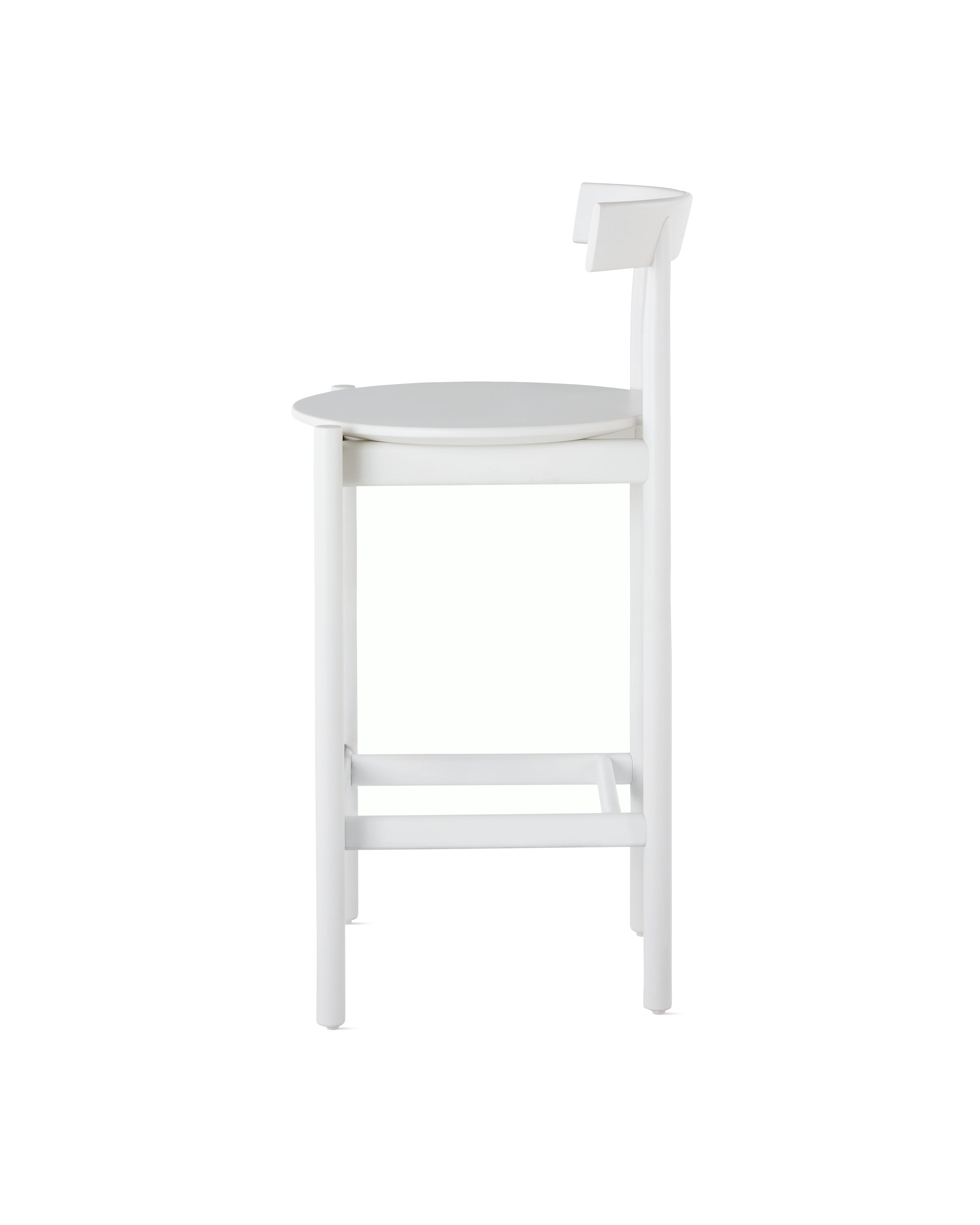 Profile view of a white counter-height Comma Stool.