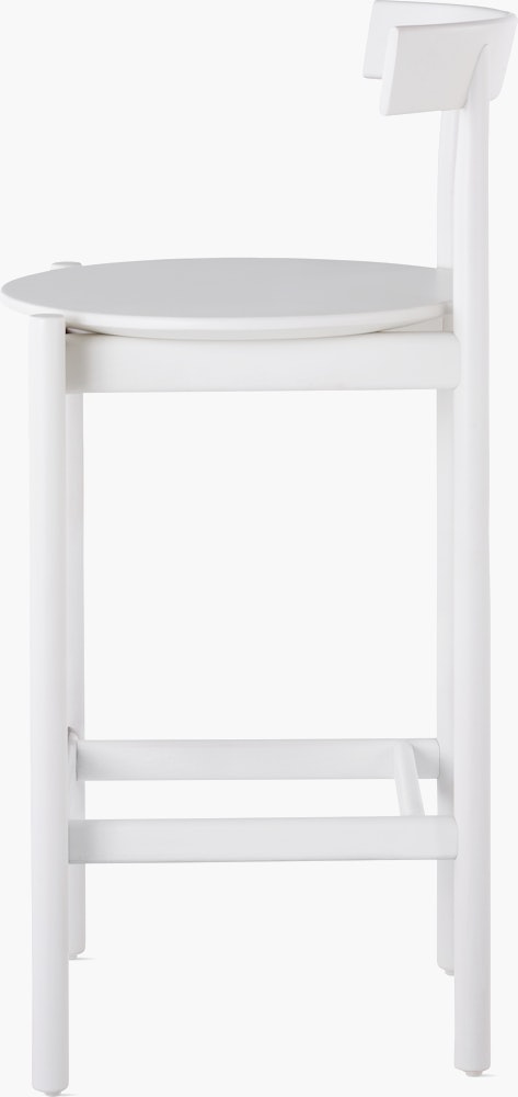 Profile view of a white counter-height Comma Stool.