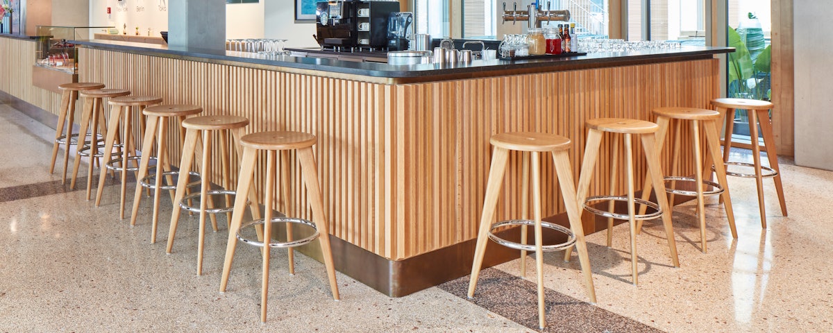 Tabouret Haut Stools in Natural Oak in a cocktail bar setting