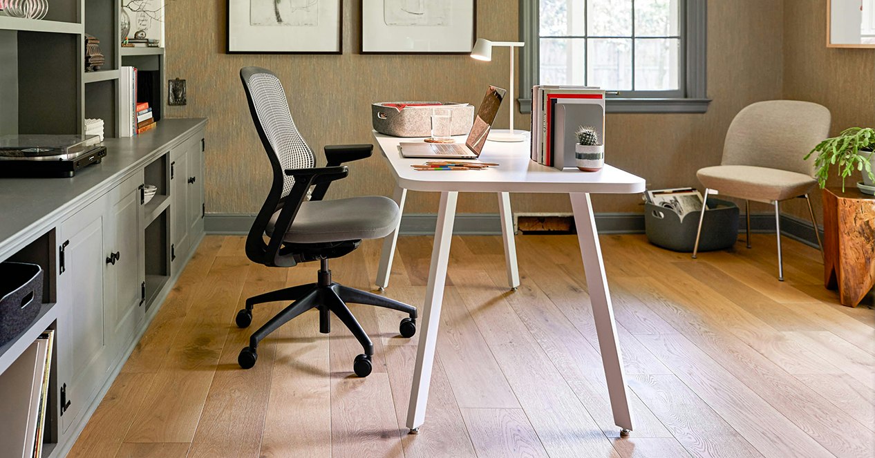 A white Rockwell Unscripted Easy Table with a ReGeneration Chair in a home office.