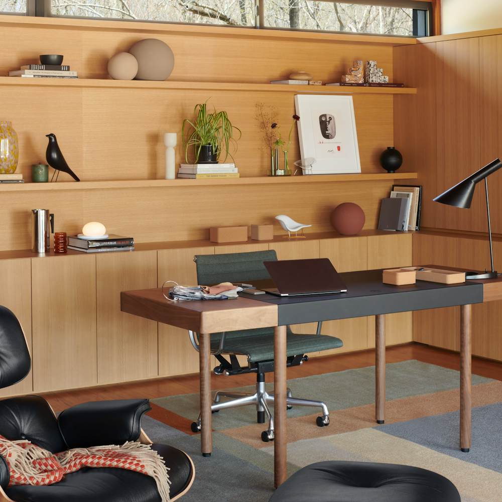 Leatherwrap Sit-to-Stand Desk, AJ Table Lamp, Landscape Rug, Eames Lounge and Ottoman, Kristina Dam Studio Globe Sculptures, Bolita Table Lamp, Eames House Bird, Nelson Face Print, Eames Aluminum Group Chair