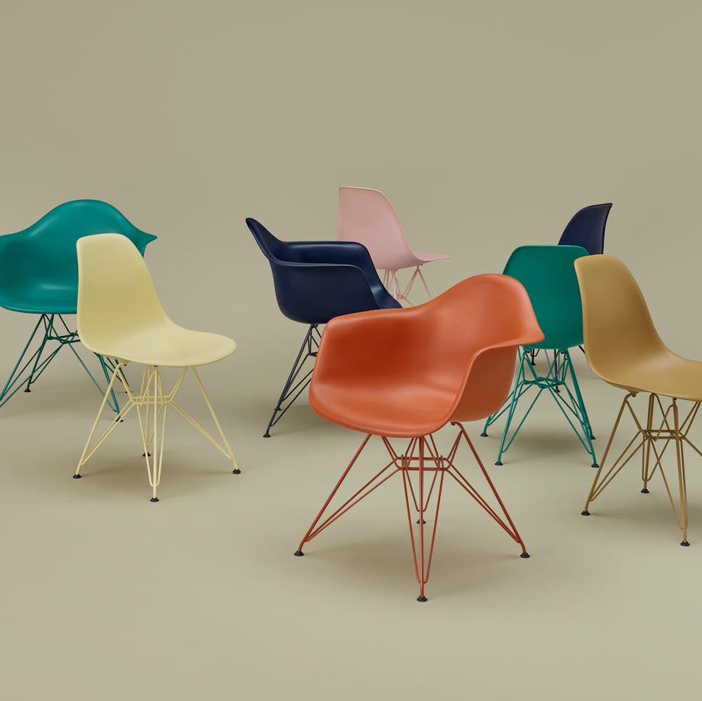 Eames Molded Plastic Chair group shot on sage ground