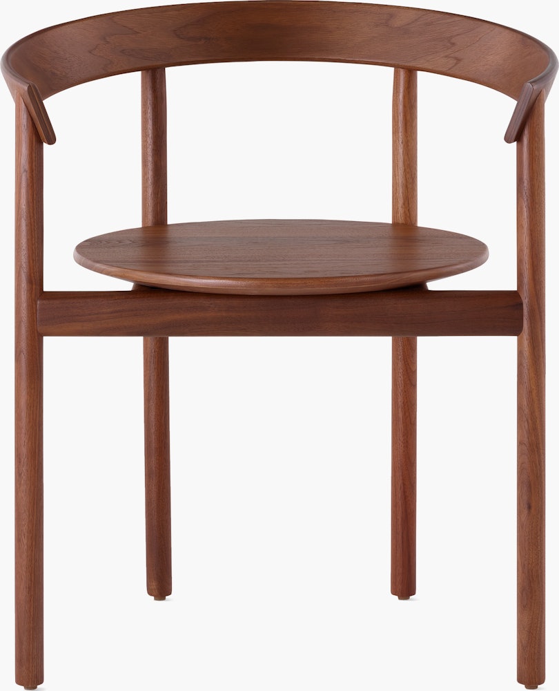 A walnut Comma Chair with arms, viewed from the front.