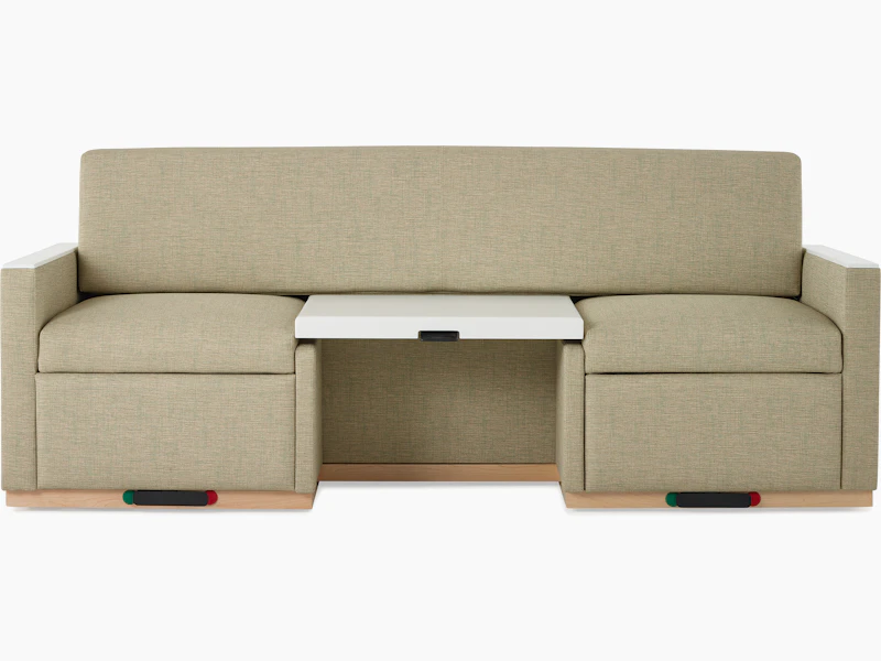 Front view of a Nemschoff Merge 2 Flop Sofa in a beige upholstery with a white center table and a natural maple base.