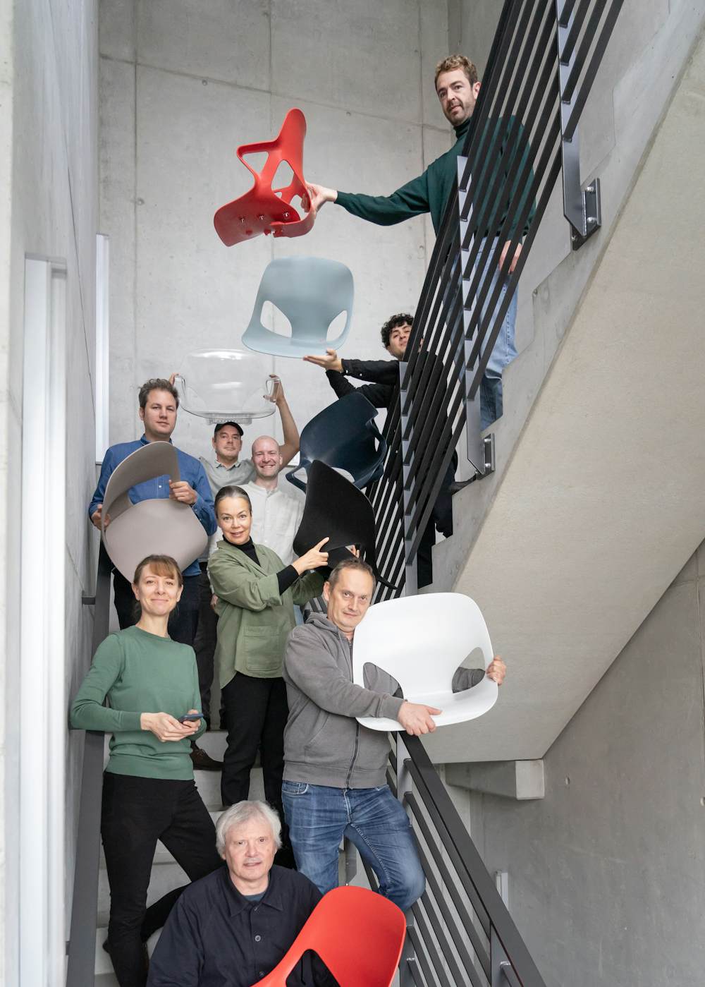 The Studio 7.5 design team standing together in a group in a stairwell.