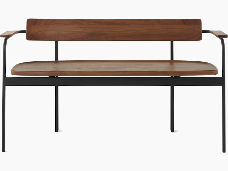 A Betwixt Bench with walnut seat, backrest, and arms with a black frame.