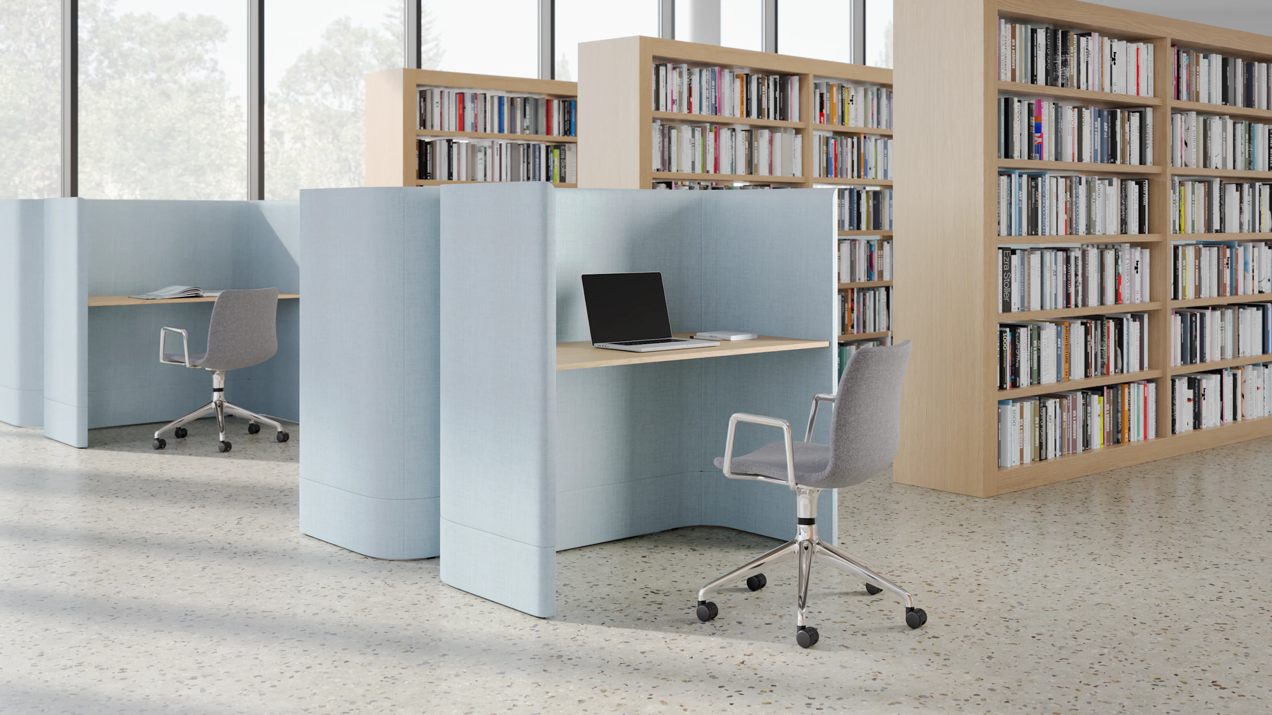 A Higher Education library setting wth several back-to-back Pulman Desk Pods upholstered in Maharam Campana.