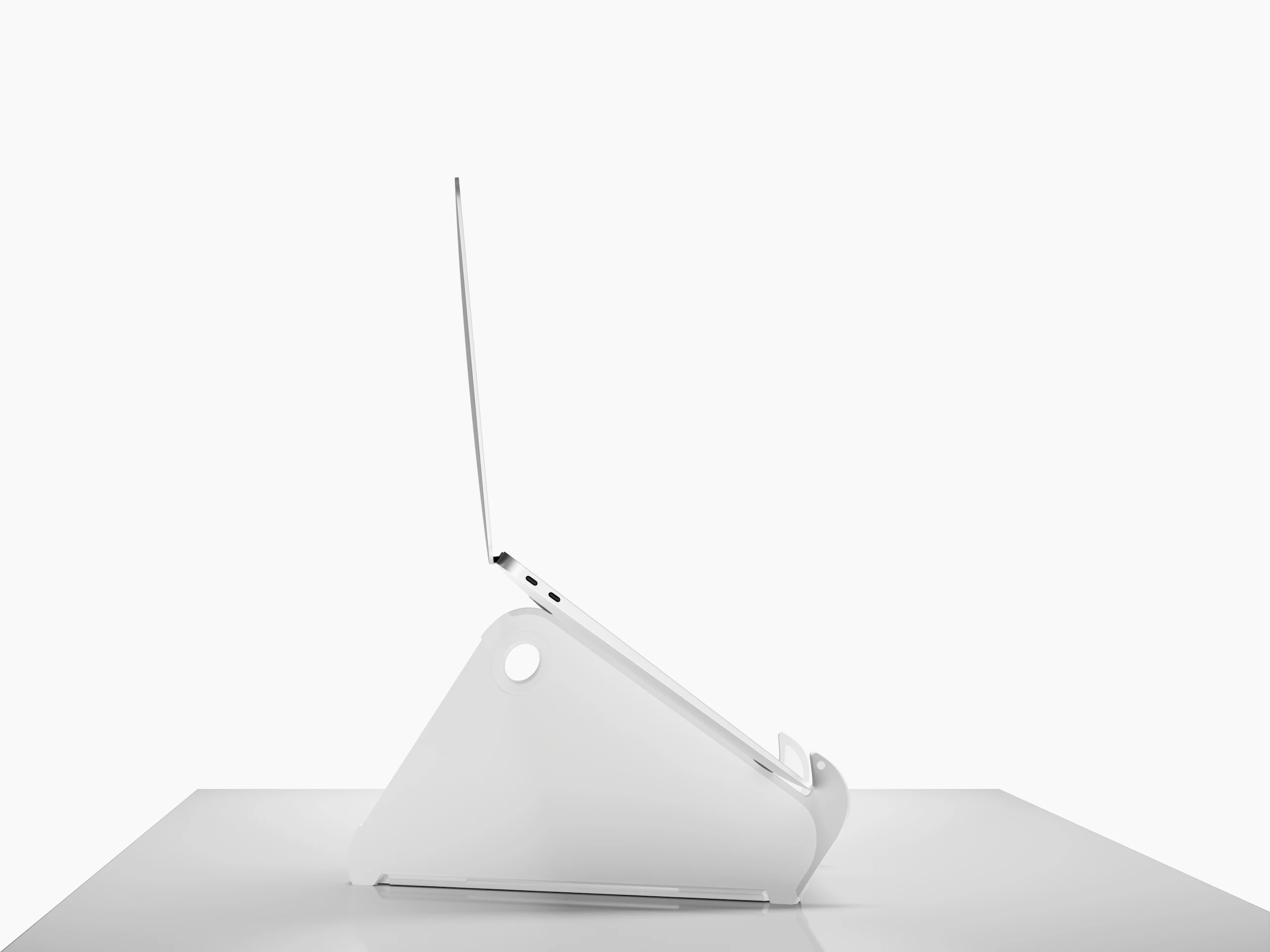 Side profile of an open and raised laptop on an Oripura Laptop Stand.