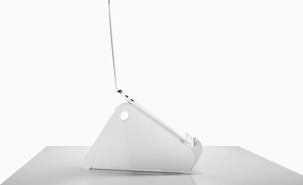 Side profile of an open and raised laptop on an Oripura Laptop Stand.