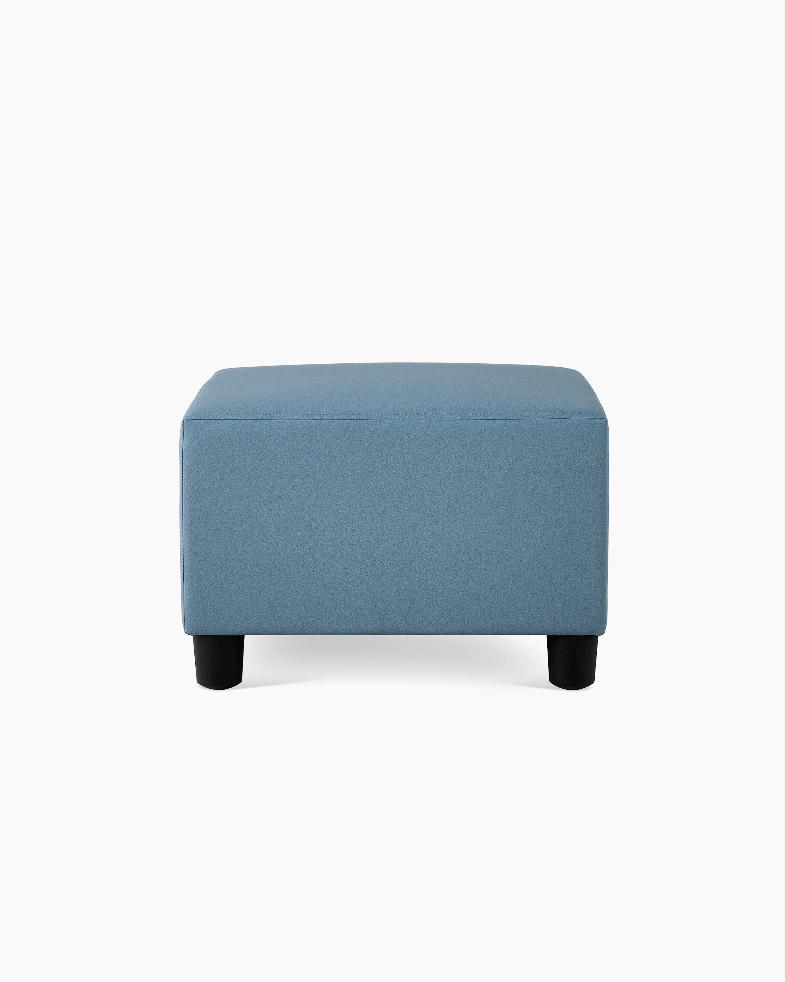 A Swoop Ottoman in blue upholstery.