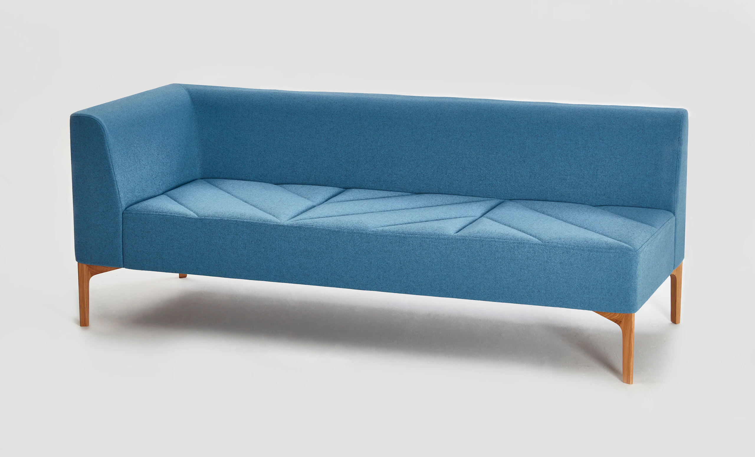 A light blue naughtone Hatch Modular Seating with right armrest and wooden base.