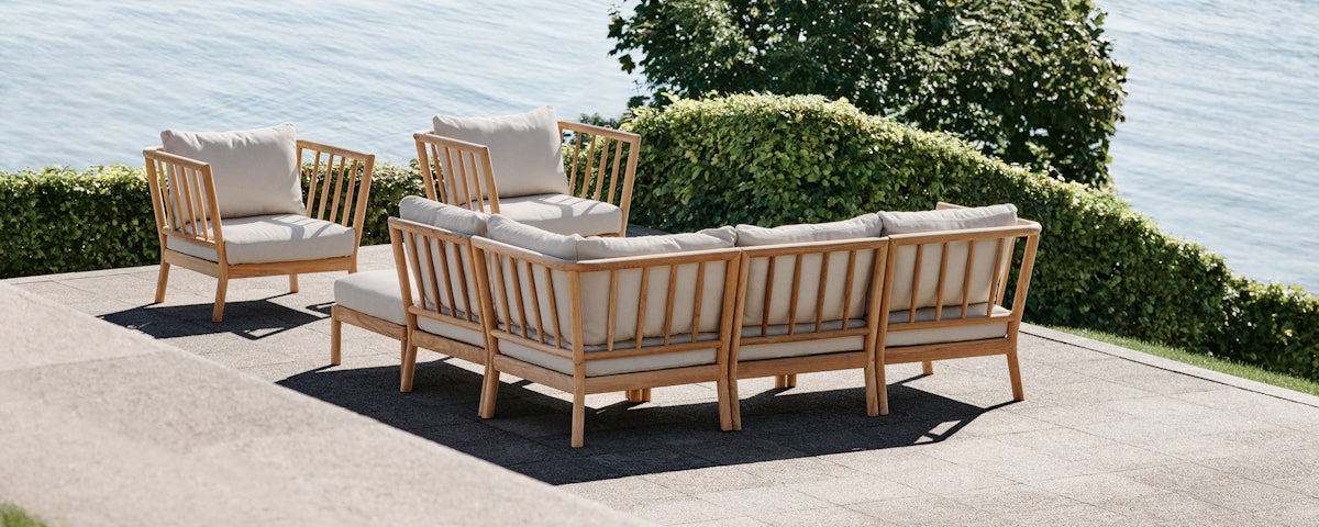 Two Tradition Outdoor Lounge Chairs and a Tradition Outdoor Sectional Sofa in an outdoor patio setting