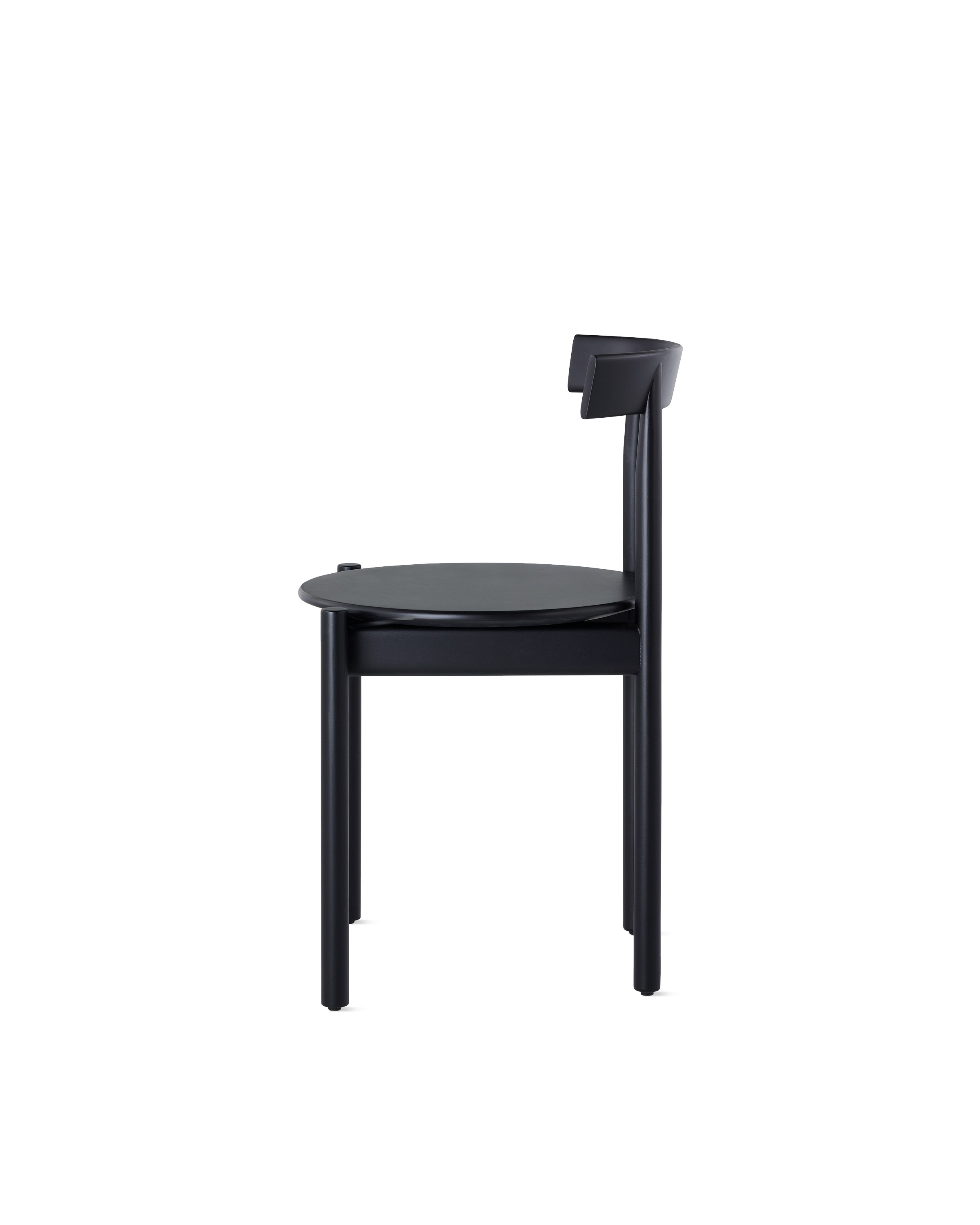 Profile view of a black Comma Chair.