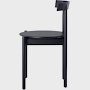 Profile view of a black Comma Chair.