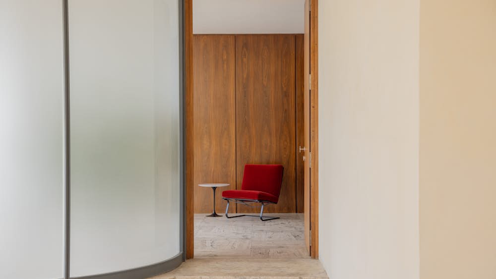 Tugendhat Chair in red velvet with a black base at Villa Tugendhat.