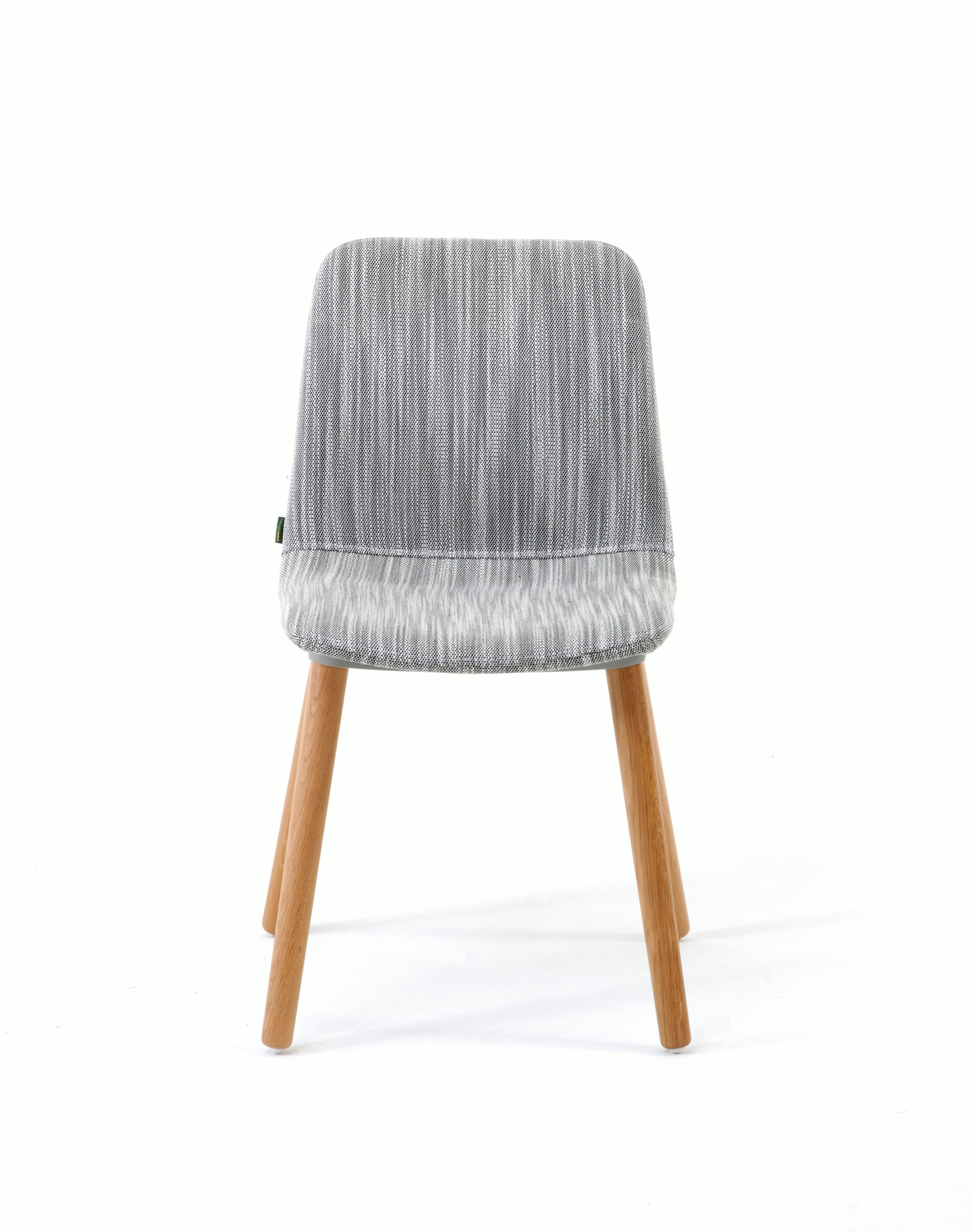White sweep shot of chair upholstered in light grey fabric on oak dowel base.