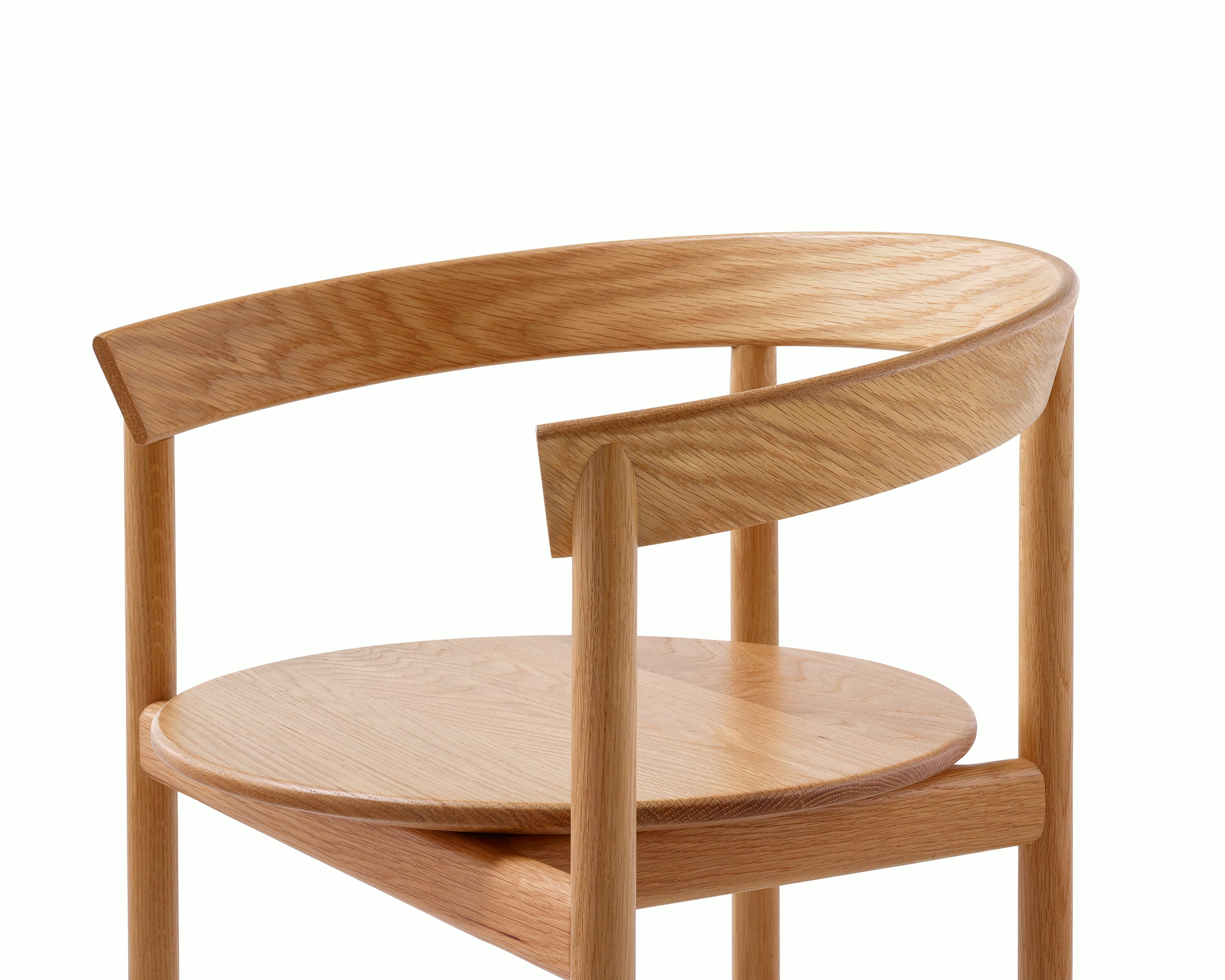 Detail shot of a Comma Chair with arms highlighting the solid frame.