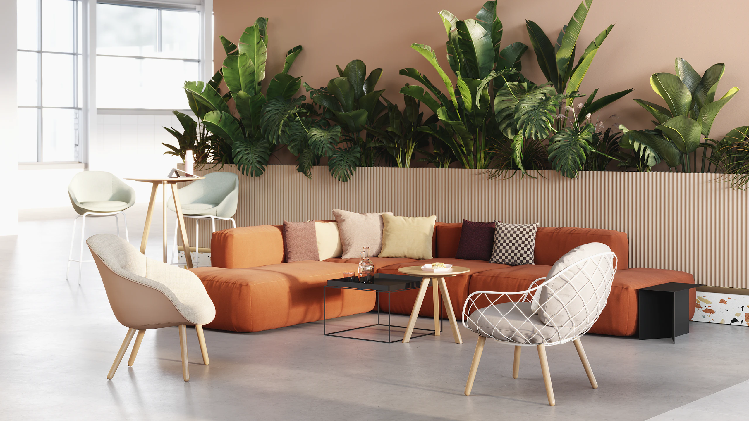 A casual lounge setting featuring sofas, chairs, and tables from HAY, naughtone, and Magis.