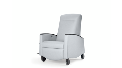 Nemschoff Sahara Recliner in a light gray upholstery with black arm caps and casters on white sweep, viewed at an angle.