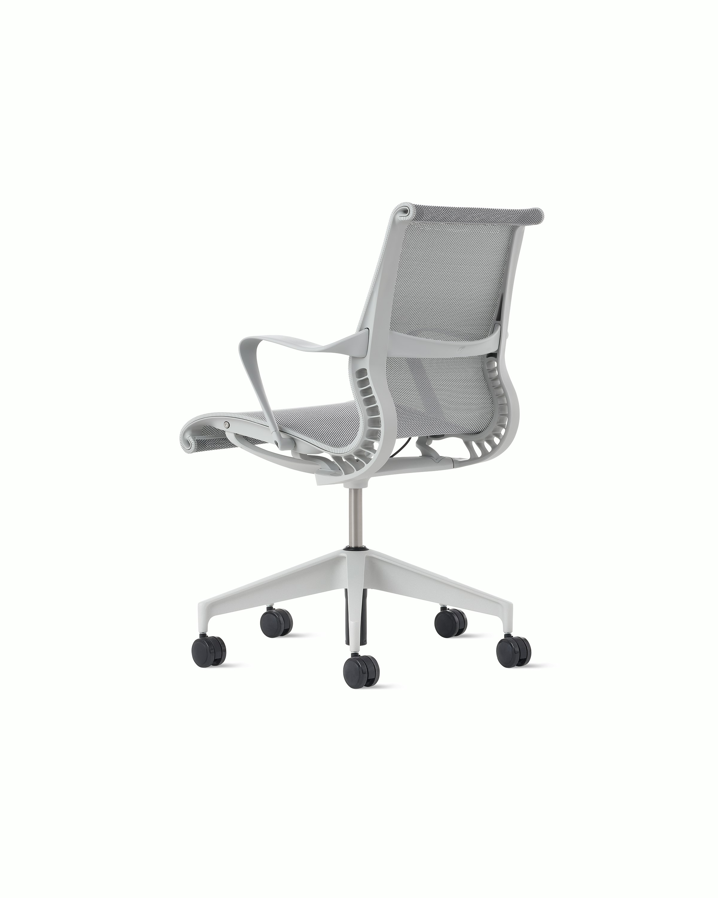 Rear angle view of a Setu chair in light grey.