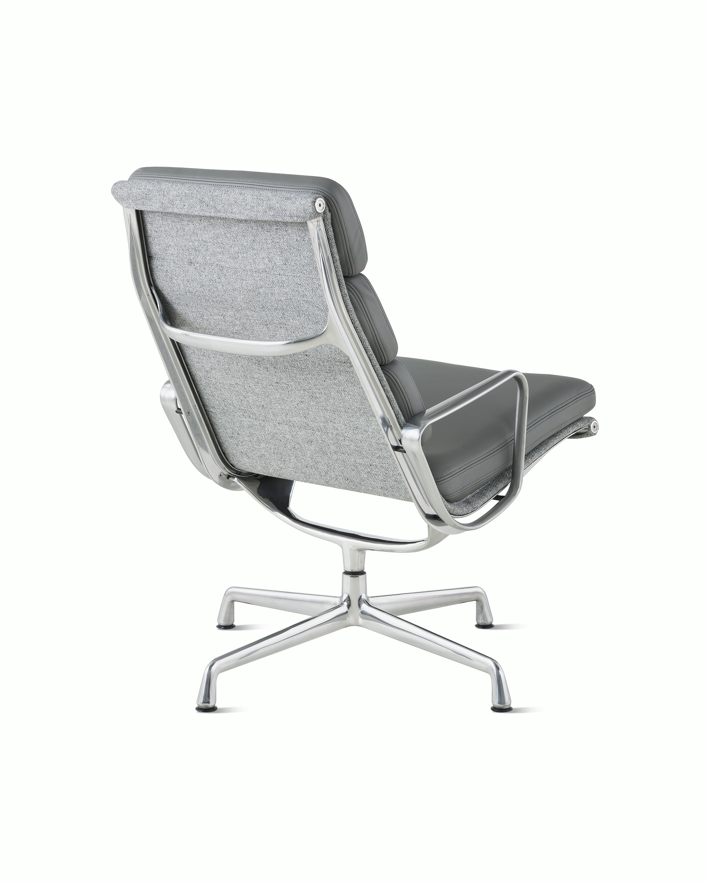 An Eames Soft Pad Lounge Chair, viewed from the back at an angle.