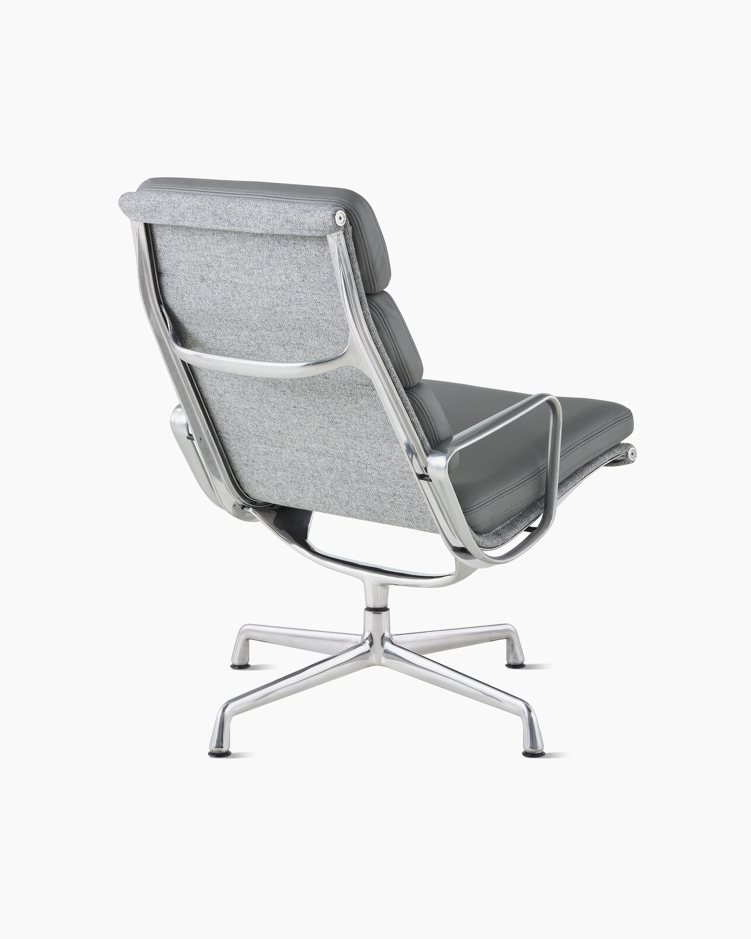 An Eames Soft Pad Lounge Chair, viewed from the back at an angle.