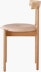 Profile view of an oak Comma Chair with a seat pad.