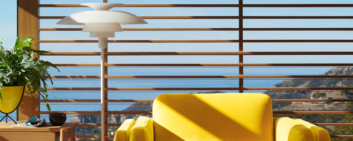 PH 80 Floor Lamp, Pastille Chair and Bullet Planter in a home living room setting
