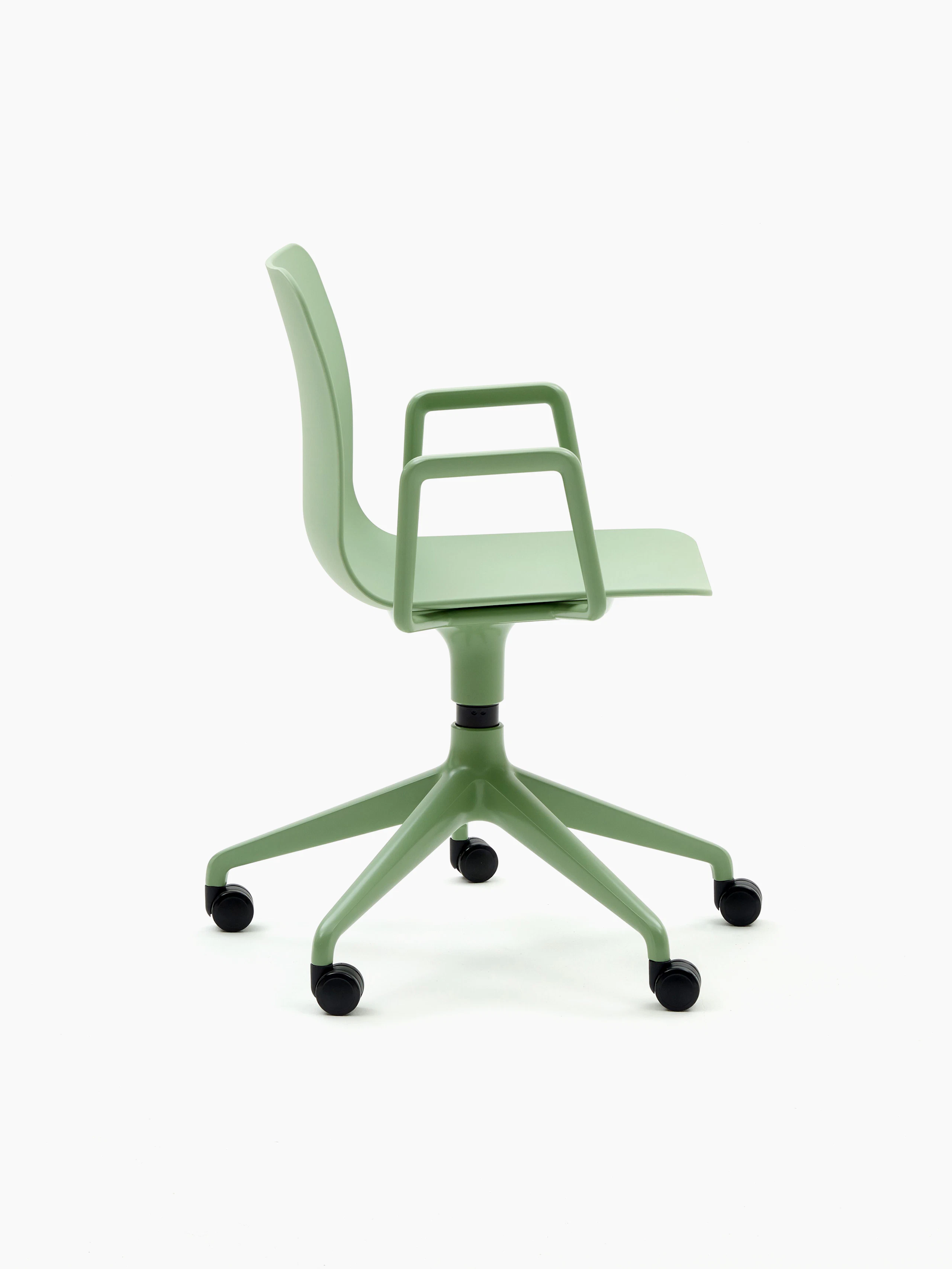 A pale green naughtone Polly Chair with a 5-star base, viewed from the side.