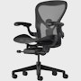 Black matte Aeron Chair on a white background with a 5-star base and ergonomic back support, viewed at an angle.