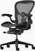 Black matte Aeron Chair on a white background with a 5-star base and ergonomic back support, viewed at an angle.