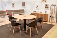 Six black Ruby chairs with oak dowel legs around a Megaped Table, with an oak veneer Sideboard and oak Hudson Coat Stand.