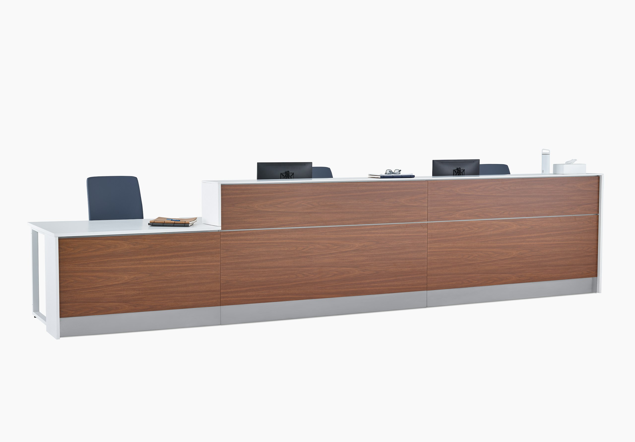 Prefab Commend Nurses Station for three with white Corian tops, dark blue Verus Chairs, walnut woodgrain laminate front and stainless steel toe kick.