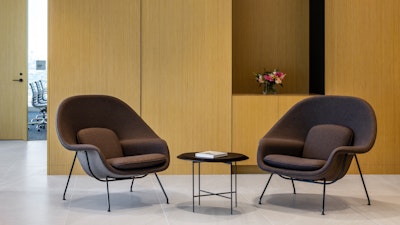 A seating area in the Blakes law firm reception area featuring two brown Knoll Womb chairs