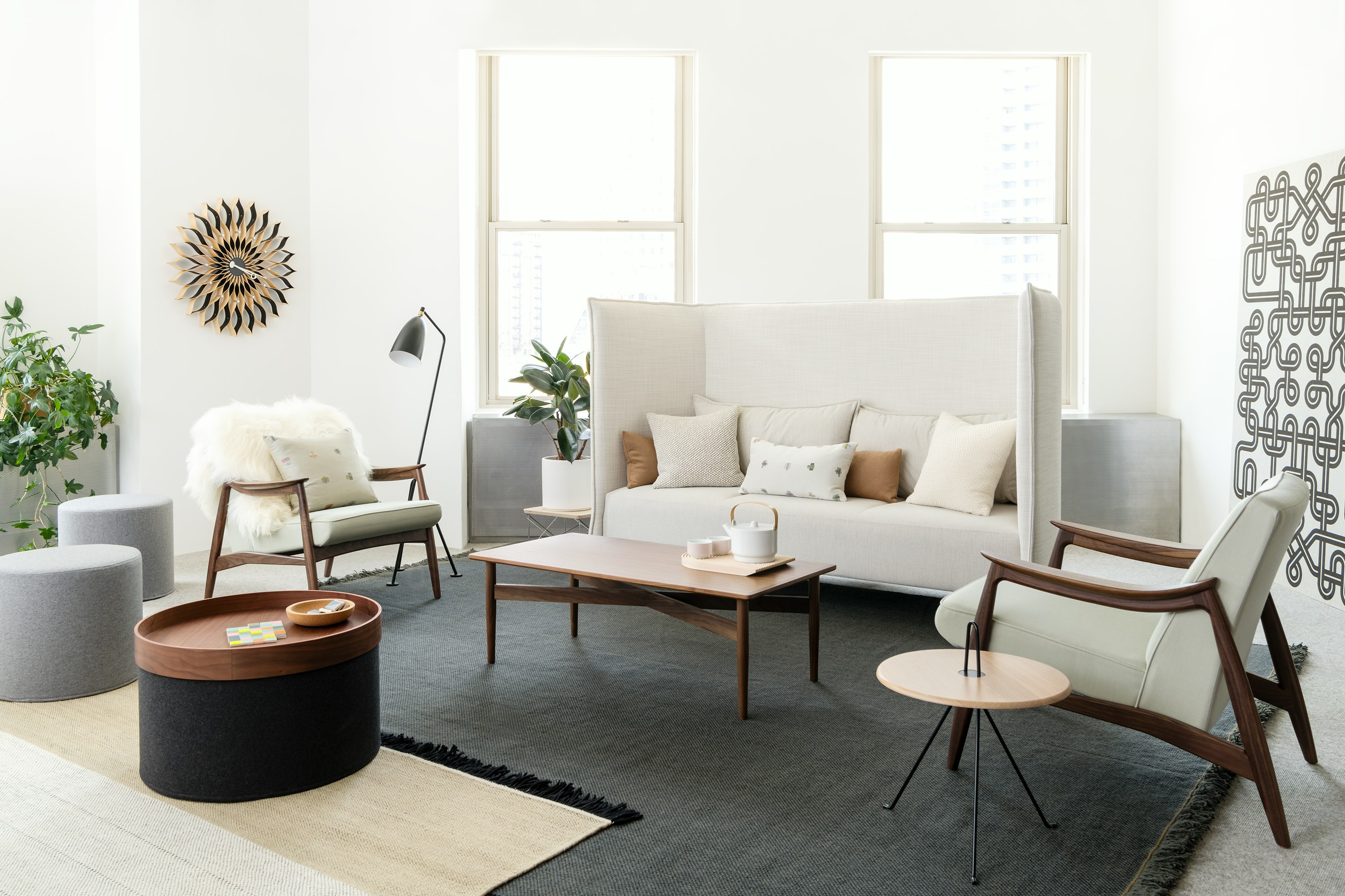 Bright lounge seating area with high-back sofa and two Aspen Lounge Chairs around a wood coffee table. Neocon 2018.